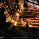 Some early Splinter Cell remake concept art of Sam Fisher on a building's raftings.